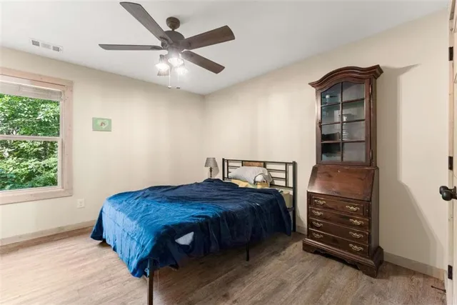 a bedroom with a bed closet and a window