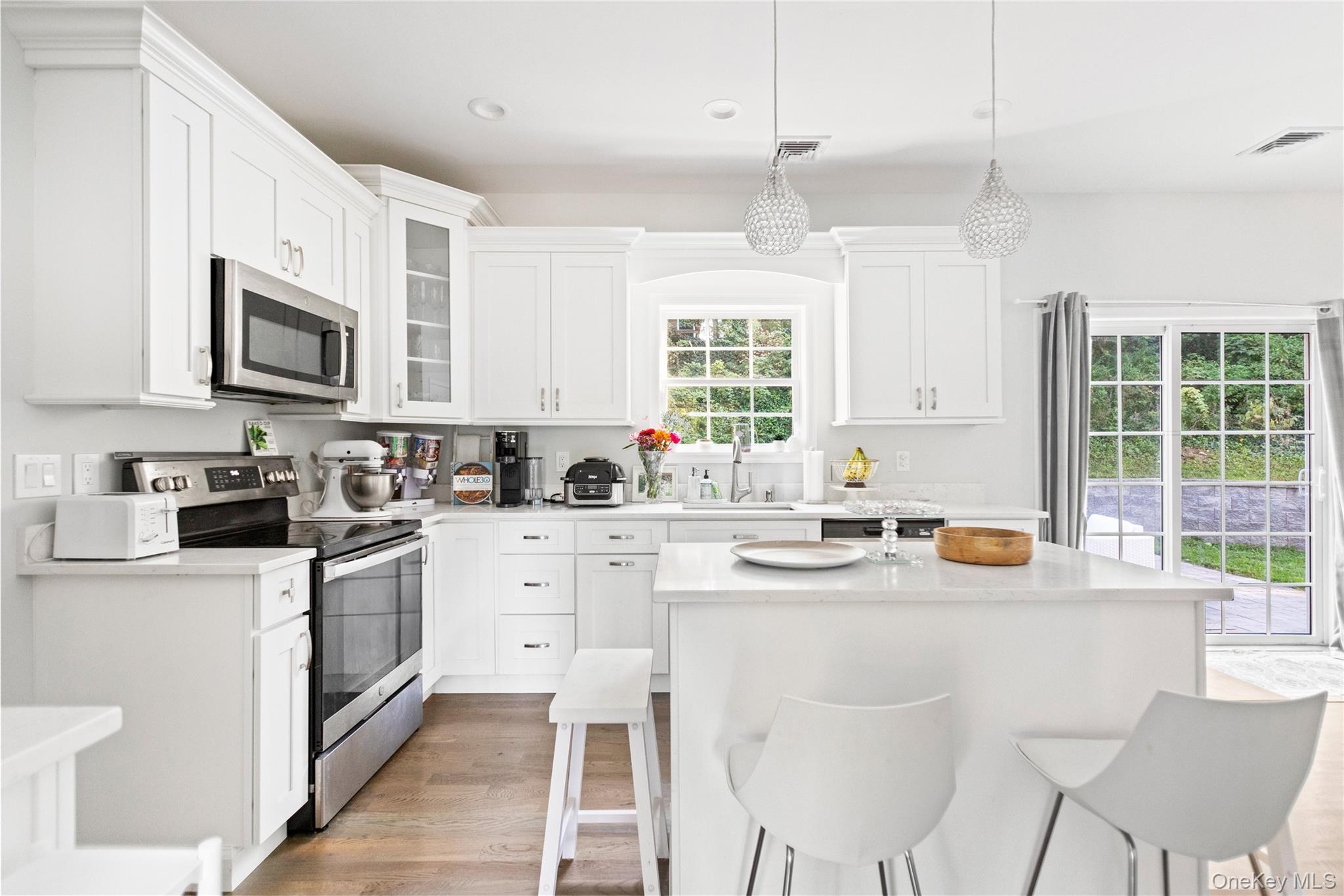24 Belmont Road Sound Beach, NY 11789 - Photo 5 of 23 a kitchen with stainless steel appliances kitchen island granite countertop a sink and cabinets
