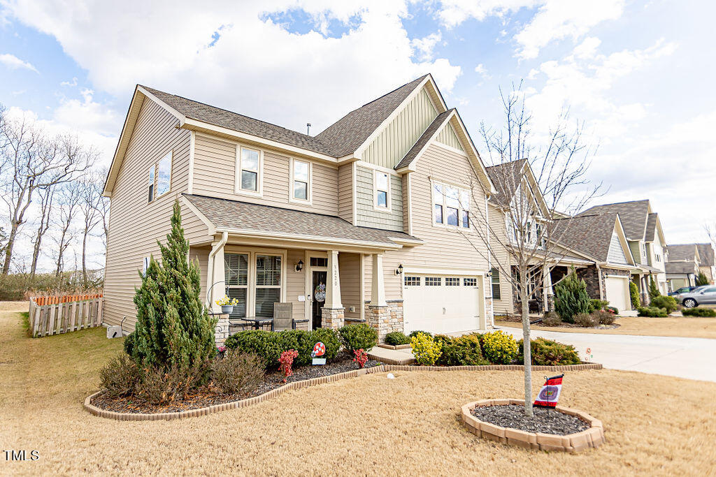 3220 Lacewing Drive Zebulon, NC 27597 - Photo 2 of 69 a front view of a house with a yard and garage