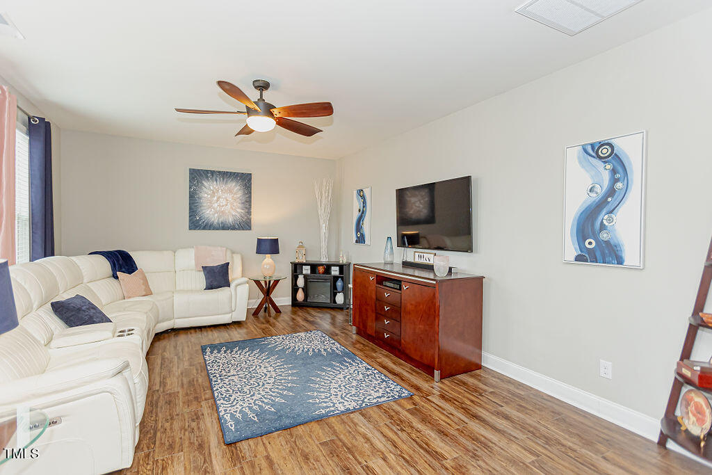 3220 Lacewing Drive Zebulon, NC 27597 - Photo 21 of 69 a living room with furniture and a flat screen tv