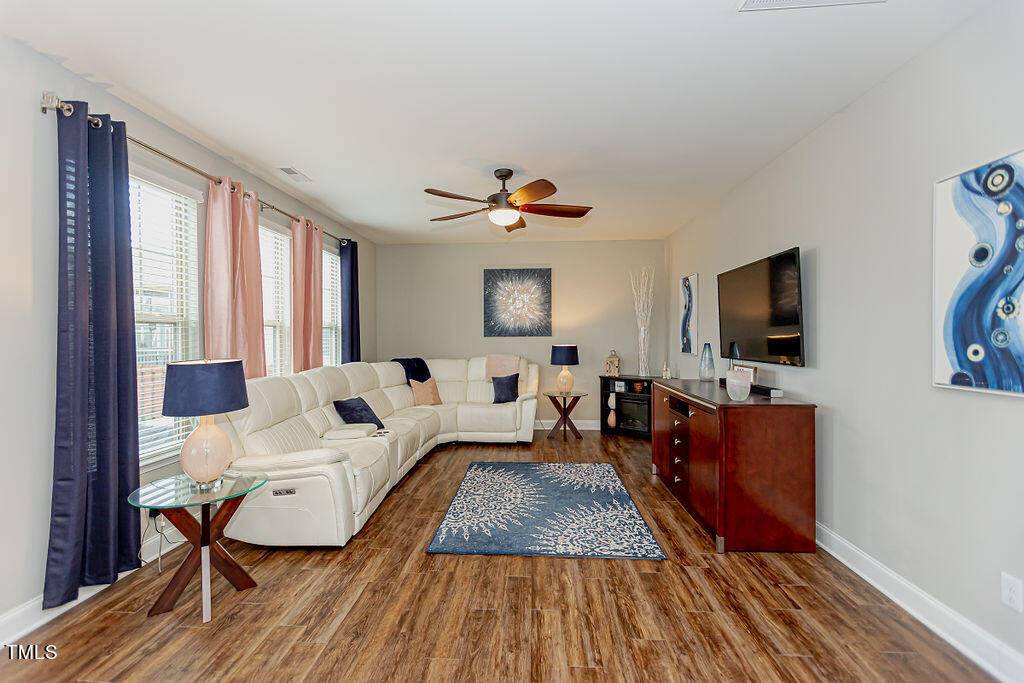 3220 Lacewing Drive Zebulon, NC 27597 - Photo 25 of 69 a living room with furniture fireplace and a flat screen tv