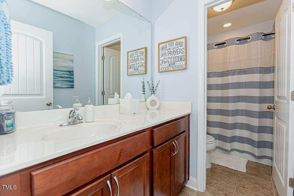 3220 Lacewing Drive Zebulon, NC 27597 - Photo 27 of 69 a bathroom with a sink and a mirror