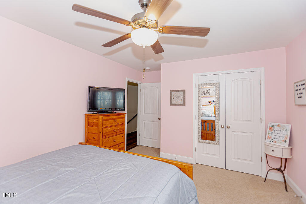 3220 Lacewing Drive Zebulon, NC 27597 - Photo 32 of 69 a bedroom with a bed and a television