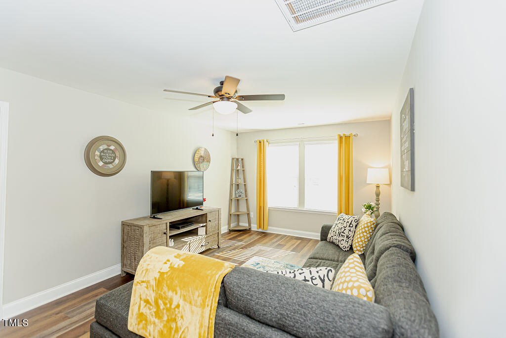 3220 Lacewing Drive Zebulon, NC 27597 - Photo 36 of 69 a bedroom with a bed and a flat screen tv