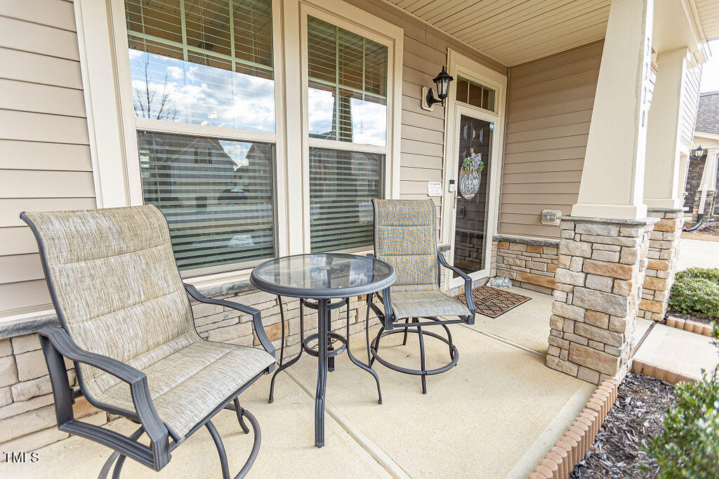 3220 Lacewing Drive Zebulon, NC 27597 - Photo 4 of 69 a view of a patio with table and chairs and potted plants