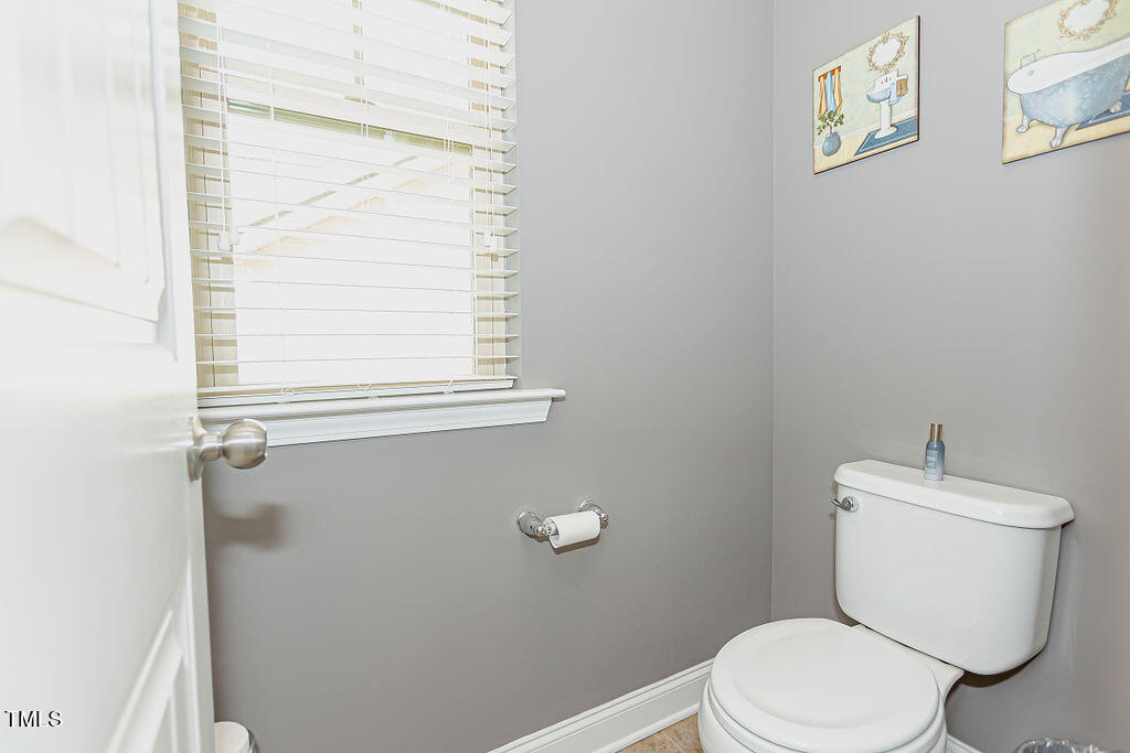 3220 Lacewing Drive Zebulon, NC 27597 - Photo 43 of 69 a white toilet sitting next to a window