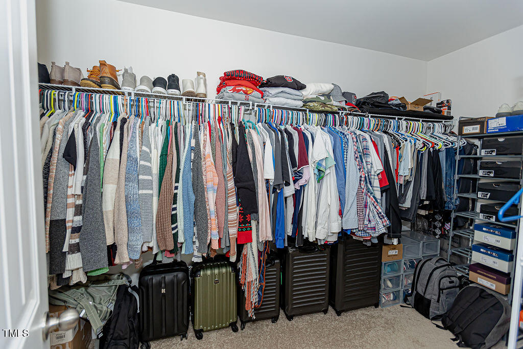 3220 Lacewing Drive Zebulon, NC 27597 - Photo 48 of 69 a view of walk in closet with clothes