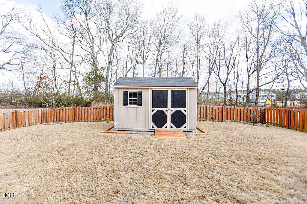 3220 Lacewing Drive Zebulon, NC 27597 - Photo 57 of 69 a view of backyard with a sitting area and wooden fence