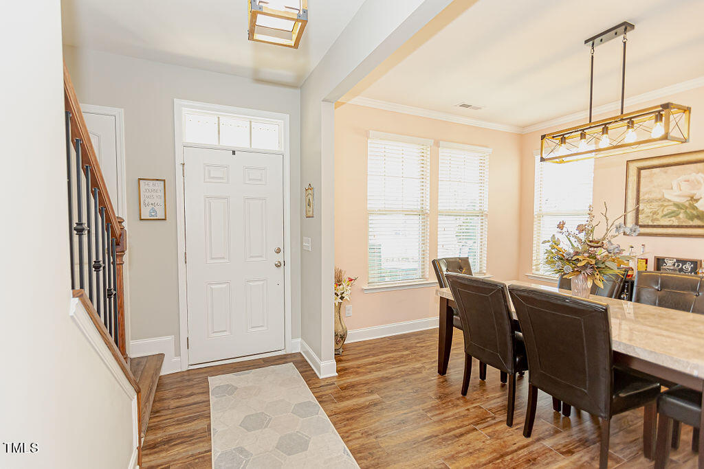 3220 Lacewing Drive Zebulon, NC 27597 - Photo 6 of 69 a view of a dining room with furniture window and wooden floor