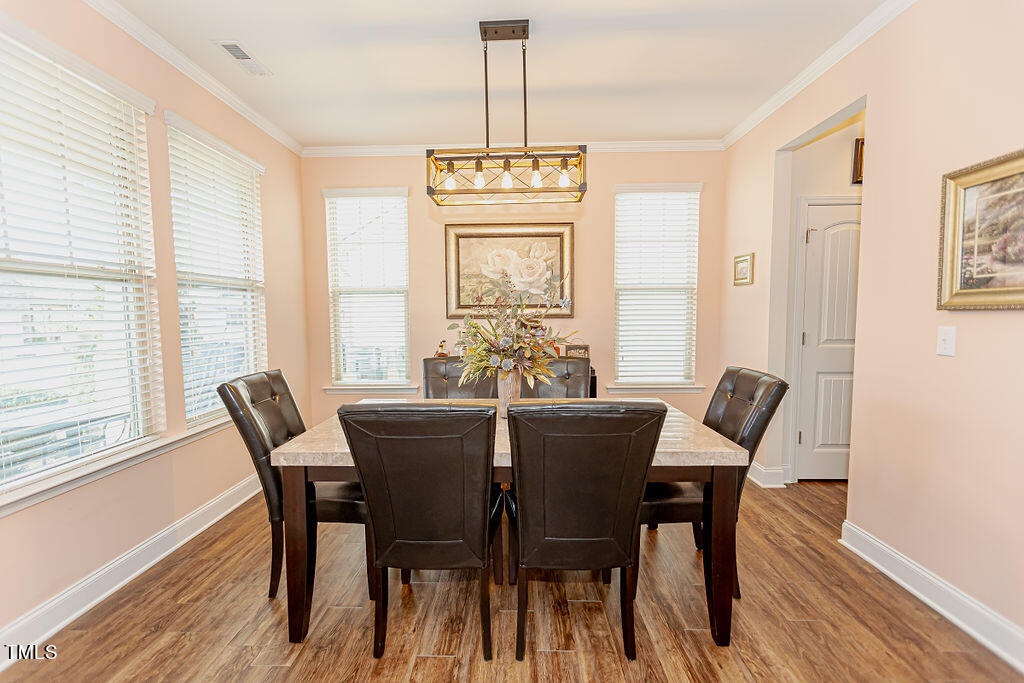 3220 Lacewing Drive Zebulon, NC 27597 - Photo 7 of 69 a view of a dining room with furniture window and wooden floor