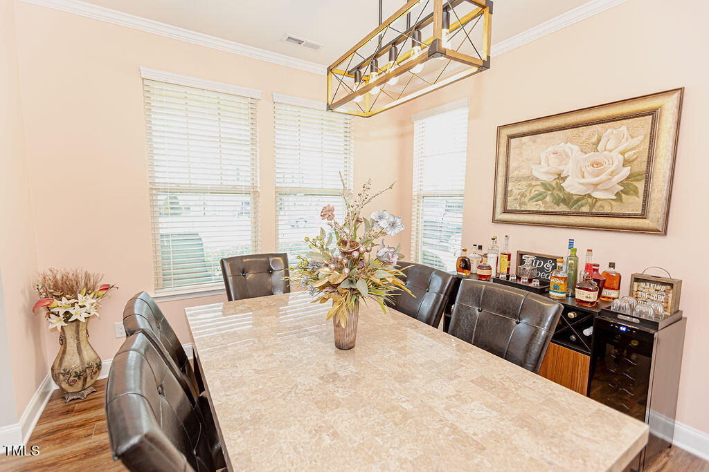 3220 Lacewing Drive Zebulon, NC 27597 - Photo 8 of 69 a view of a dining room with furniture window and wooden floor