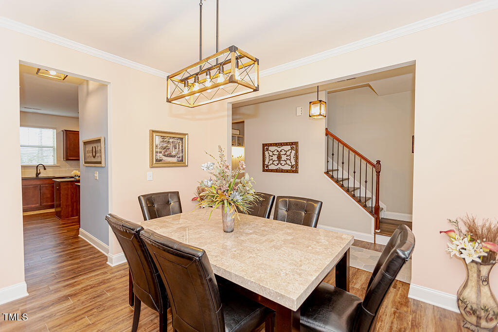 3220 Lacewing Drive Zebulon, NC 27597 - Photo 10 of 69 a view of a dining room with furniture and wooden floor