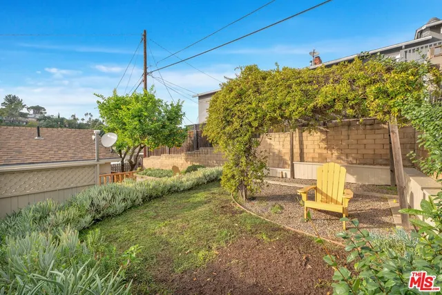 a view of a chair and table in the garden