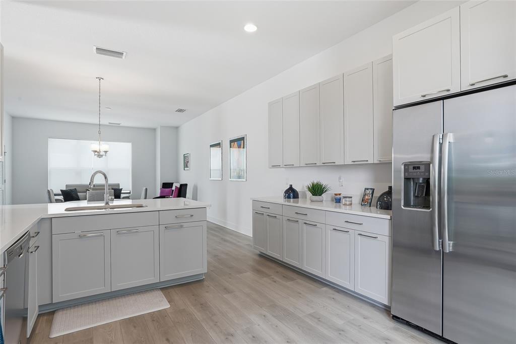 4810 West McElroy Avenue, Unit 30 Tampa, FL 33611 - Photo 19 of 43 a kitchen with white cabinets and stainless steel appliances