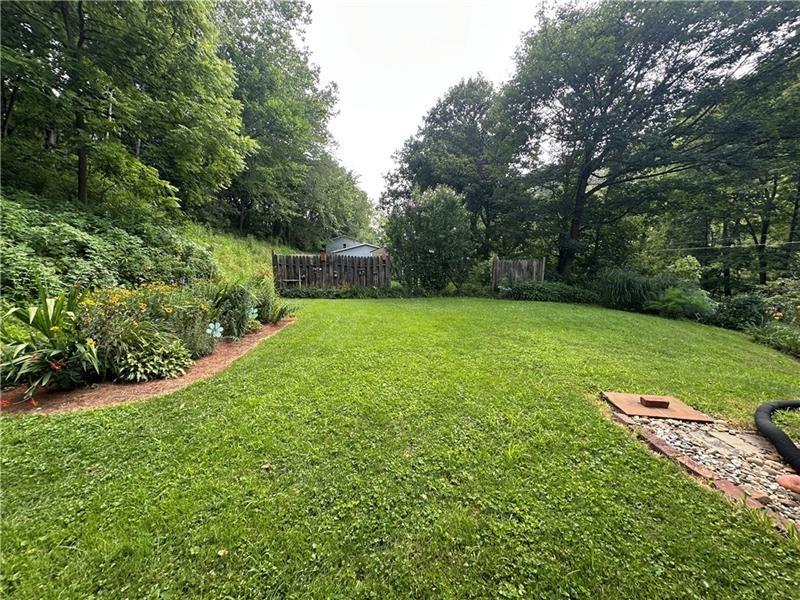 944 Van Gorder Mill Road Ellwood City, PA 16117 - Photo 11 of 48 a view of a backyard with large trees