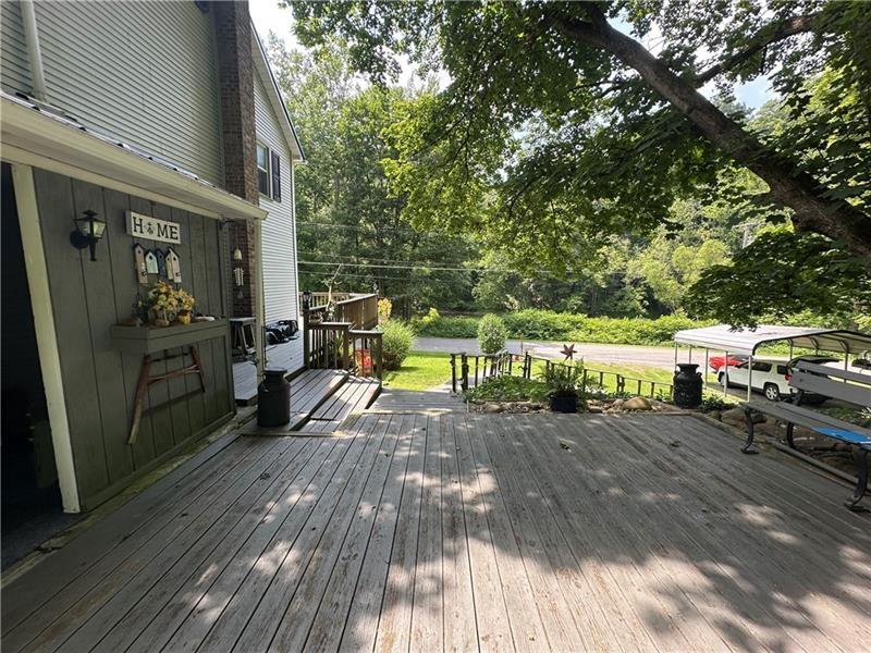 944 Van Gorder Mill Road Ellwood City, PA 16117 - Photo 16 of 48 a view of a deck with table and chairs with wooden floor and fence