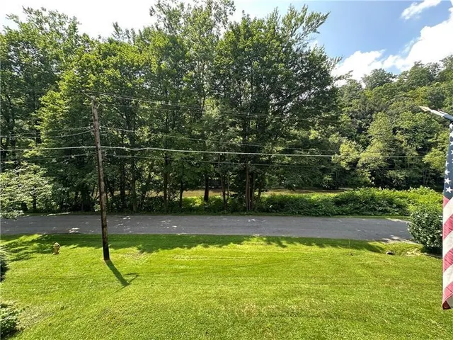 a view of a swimming pool with a yard