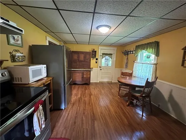 a kitchen with stainless steel appliances granite countertop a refrigerator and microwave