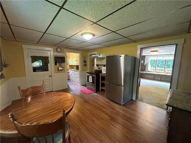 a view of an empty room with glass door and furniture