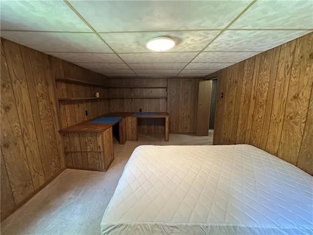 a bedroom with a bed and a mirror