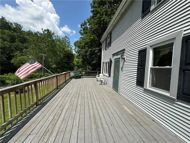 a living room with furniture a chandelier and a large window