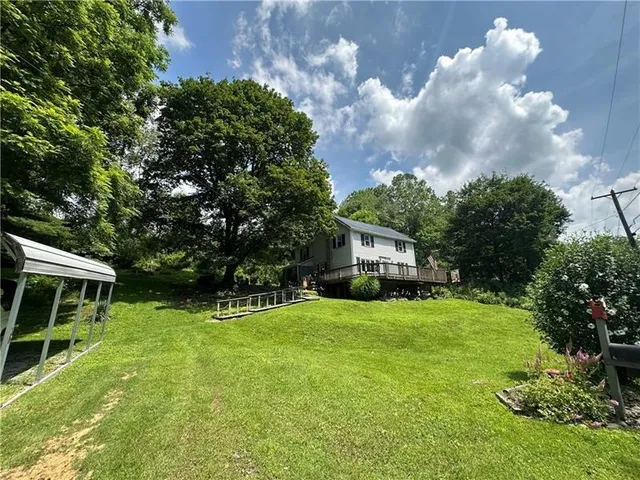 a view of house with a big yard