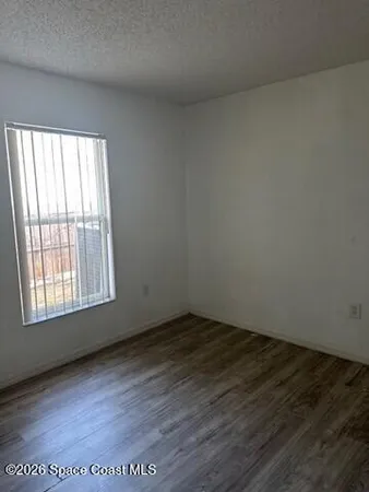 an empty room with wooden floor