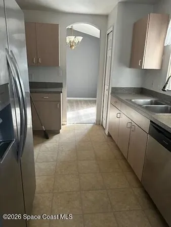 a kitchen with granite countertop a refrigerator and a stove