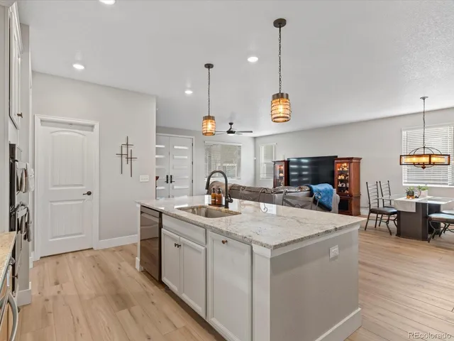 a kitchen with granite countertop a stove and a sink