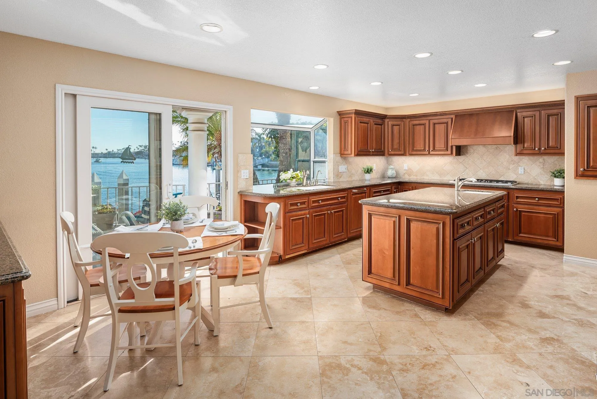 2 The Point Coronado, CA 92118 - Photo 16 of 54 a kitchen with stainless steel appliances granite countertop a stove and a refrigerator