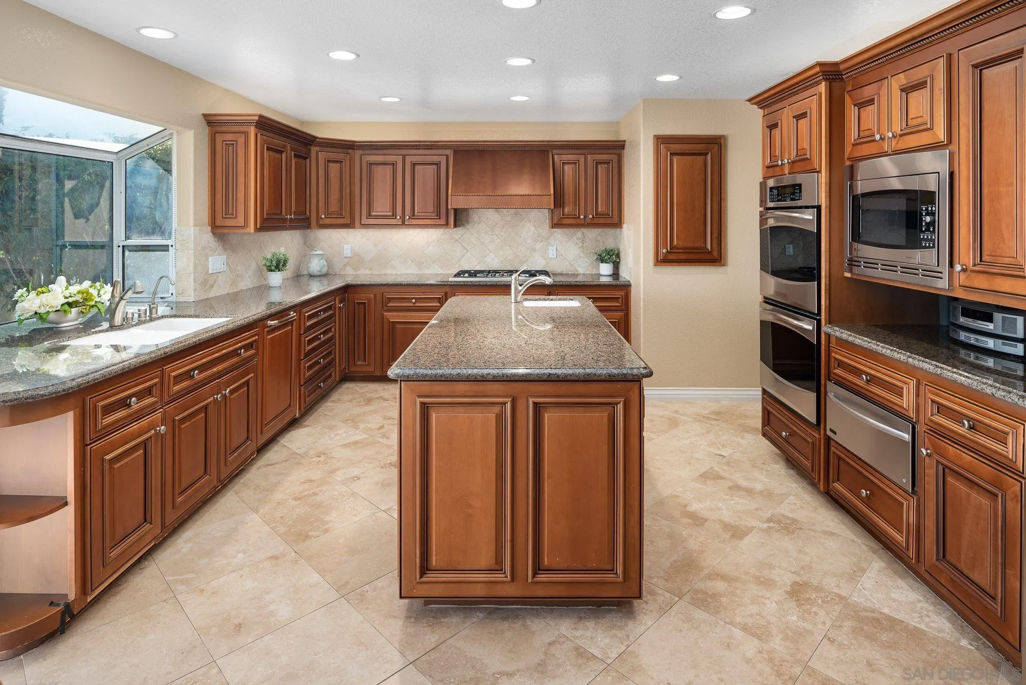 2 The Point Coronado, CA 92118 - Photo 17 of 54 a kitchen with stainless steel appliances granite countertop wooden cabinets a granite counter tops and a sink