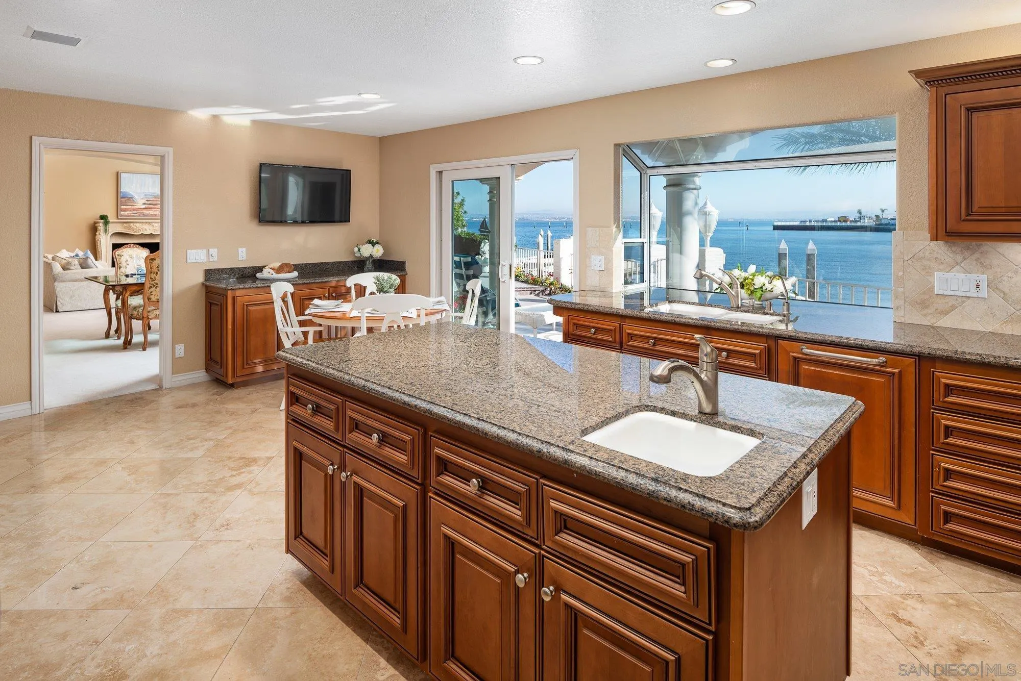 2 The Point Coronado, CA 92118 - Photo 19 of 54 a spacious kitchen with stainless steel appliances granite countertop a sink and a microwave