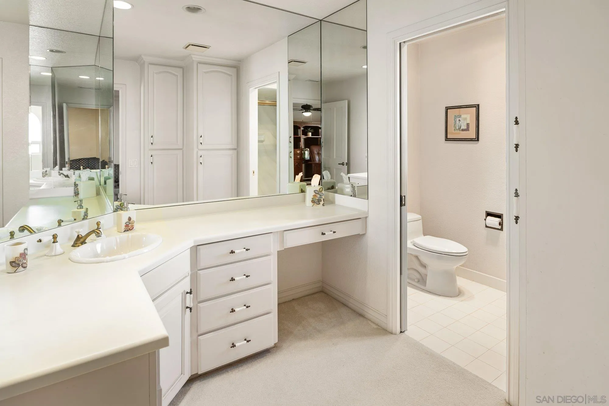 2 The Point Coronado, CA 92118 - Photo 44 of 54 a bathroom with a sink a toilet and a large mirror