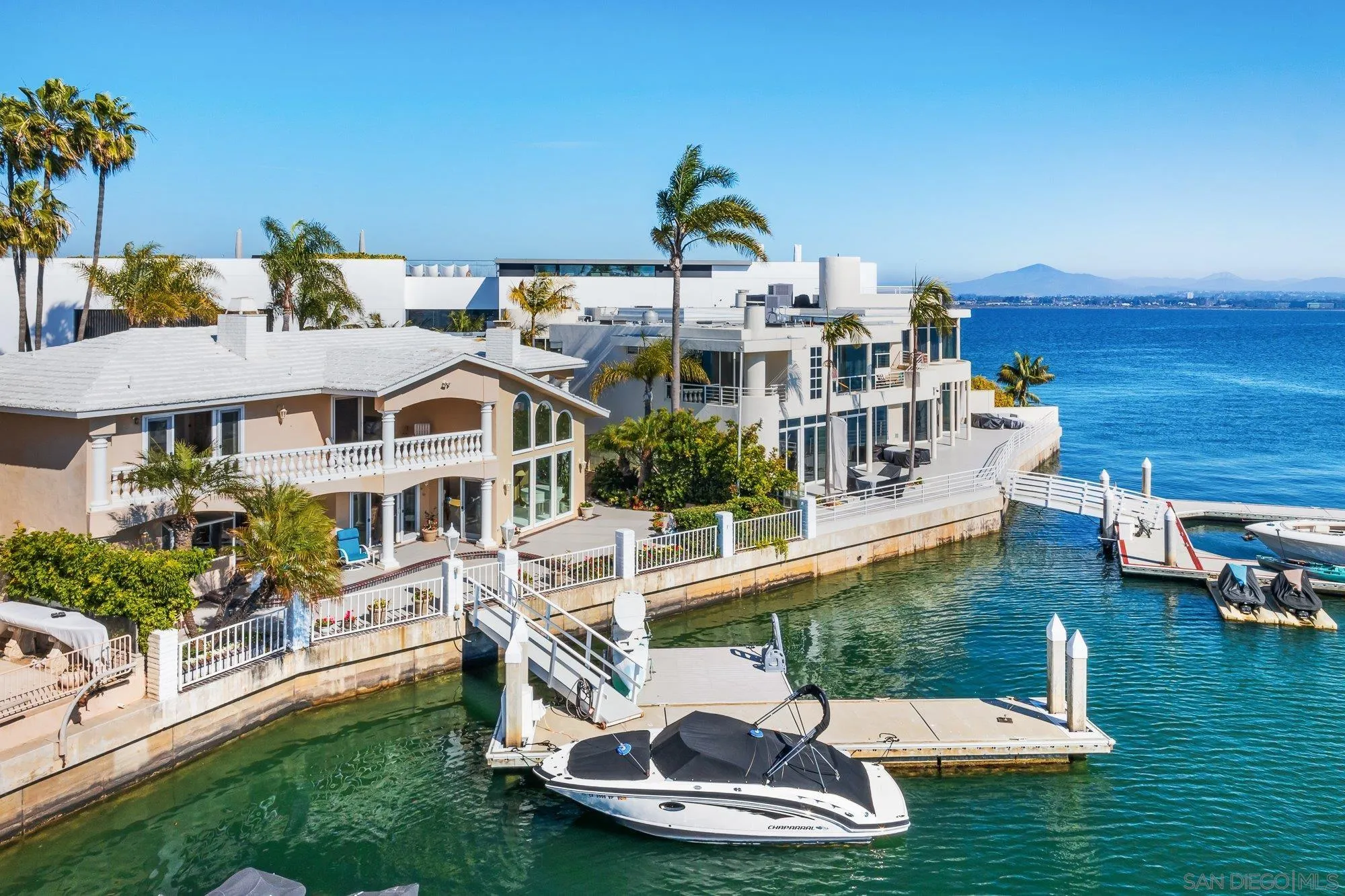 2 The Point Coronado, CA 92118 - Photo 49 of 54 a view of a white house with swimming pool lawn chairs and a yard