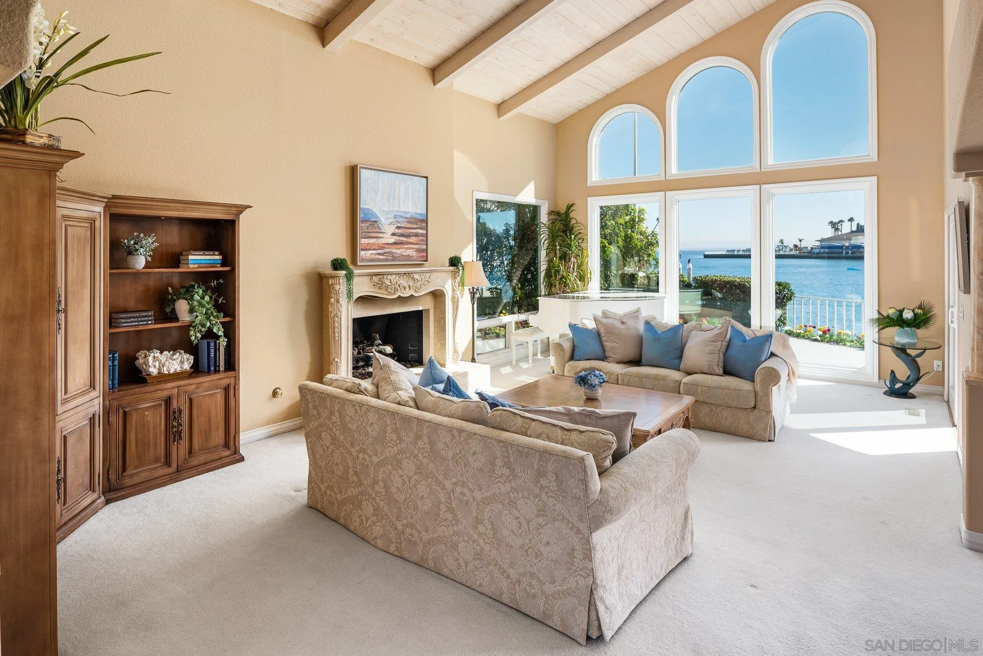 2 The Point Coronado, CA 92118 - Photo 9 of 54 a living room with furniture a large window and a fireplace