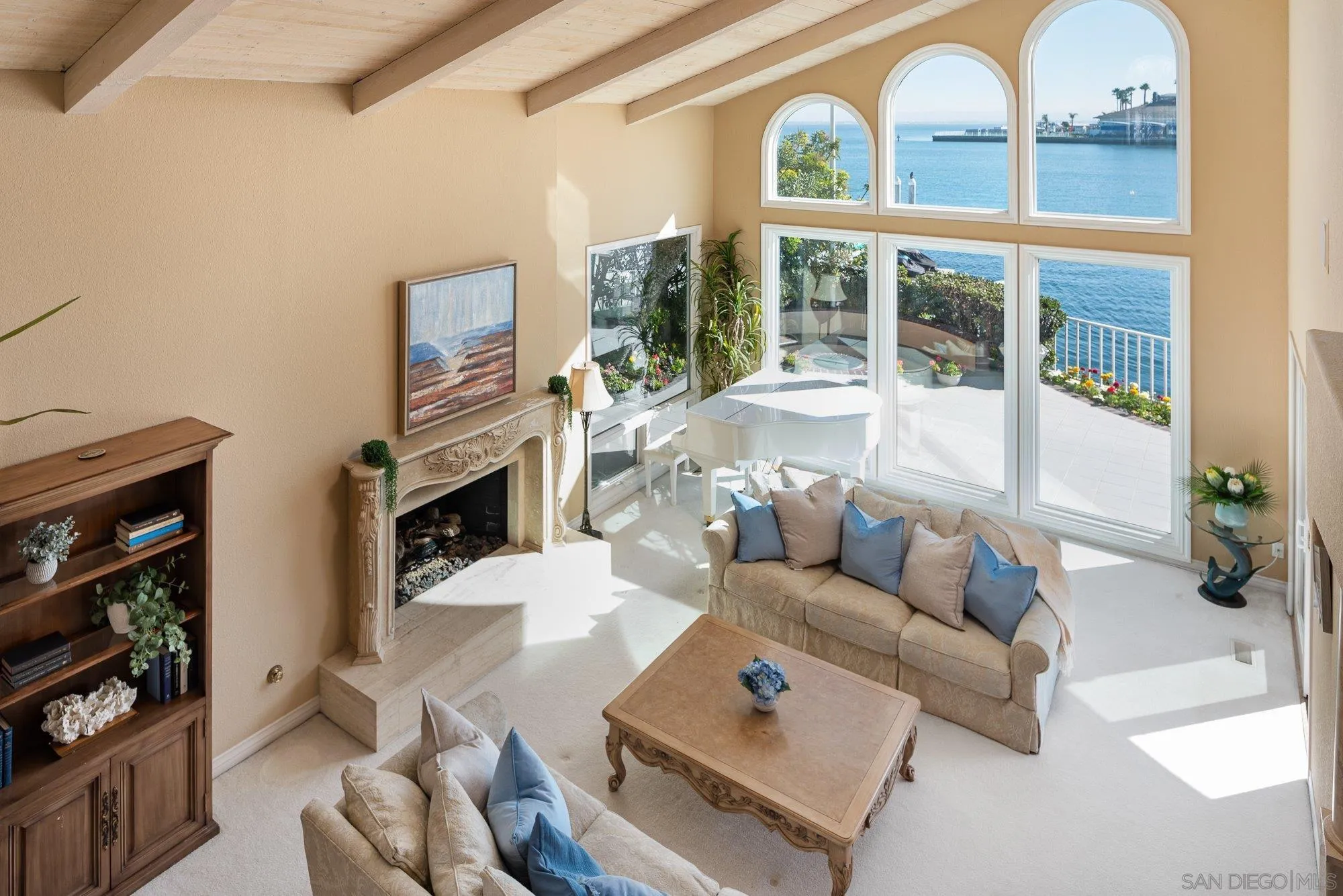 2 The Point Coronado, CA 92118 - Photo 10 of 54 a living room with furniture a fireplace and a floor to ceiling window
