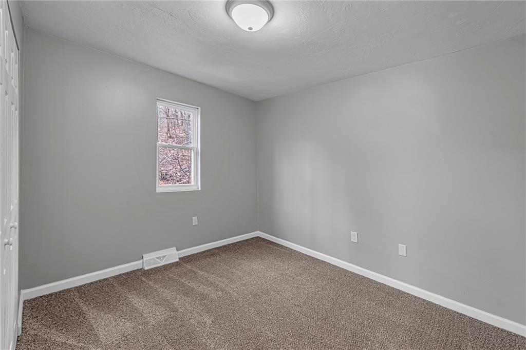 814 Breakneck Road Connellsville, PA 15425 - Photo 11 of 25 an empty room with a empty space and window