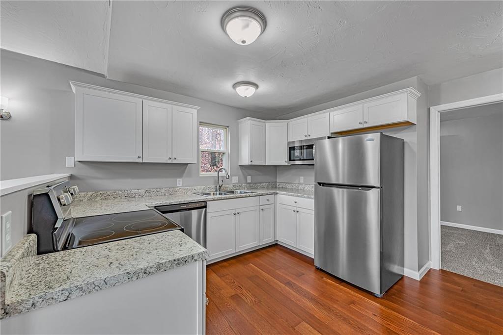 814 Breakneck Road Connellsville, PA 15425 - Photo 8 of 25 a kitchen with a refrigerator sink and cabinets