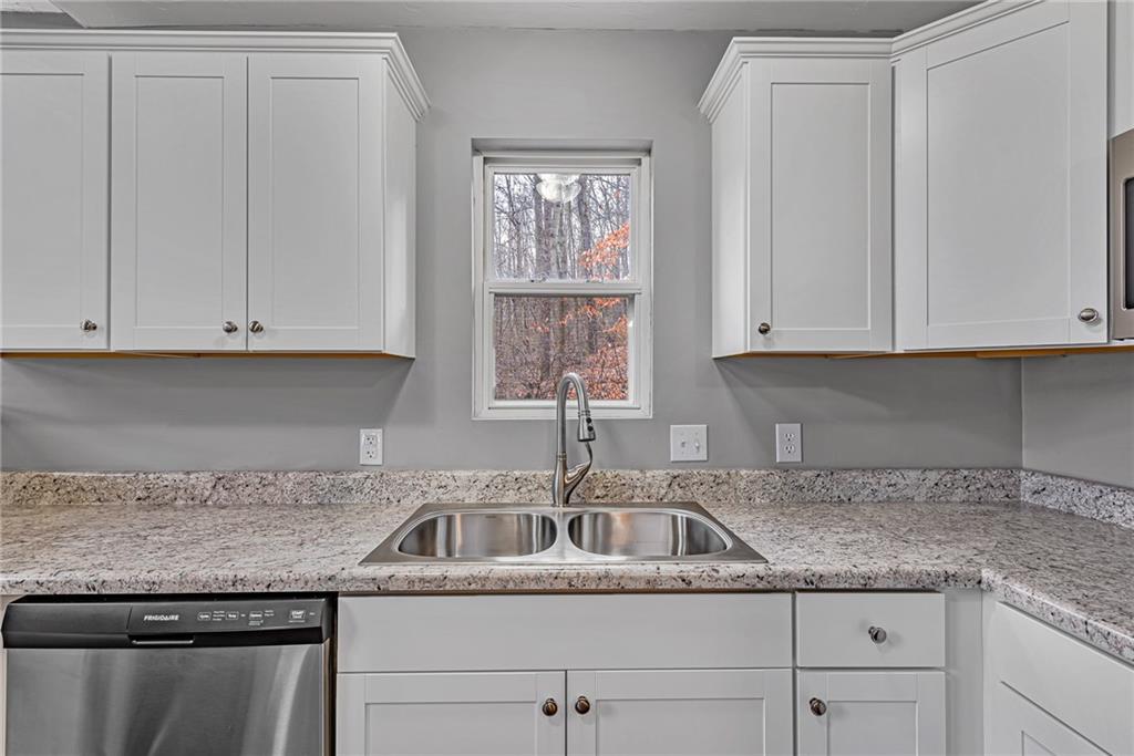 814 Breakneck Road Connellsville, PA 15425 - Photo 10 of 25 a kitchen with granite countertop white cabinets and a sink