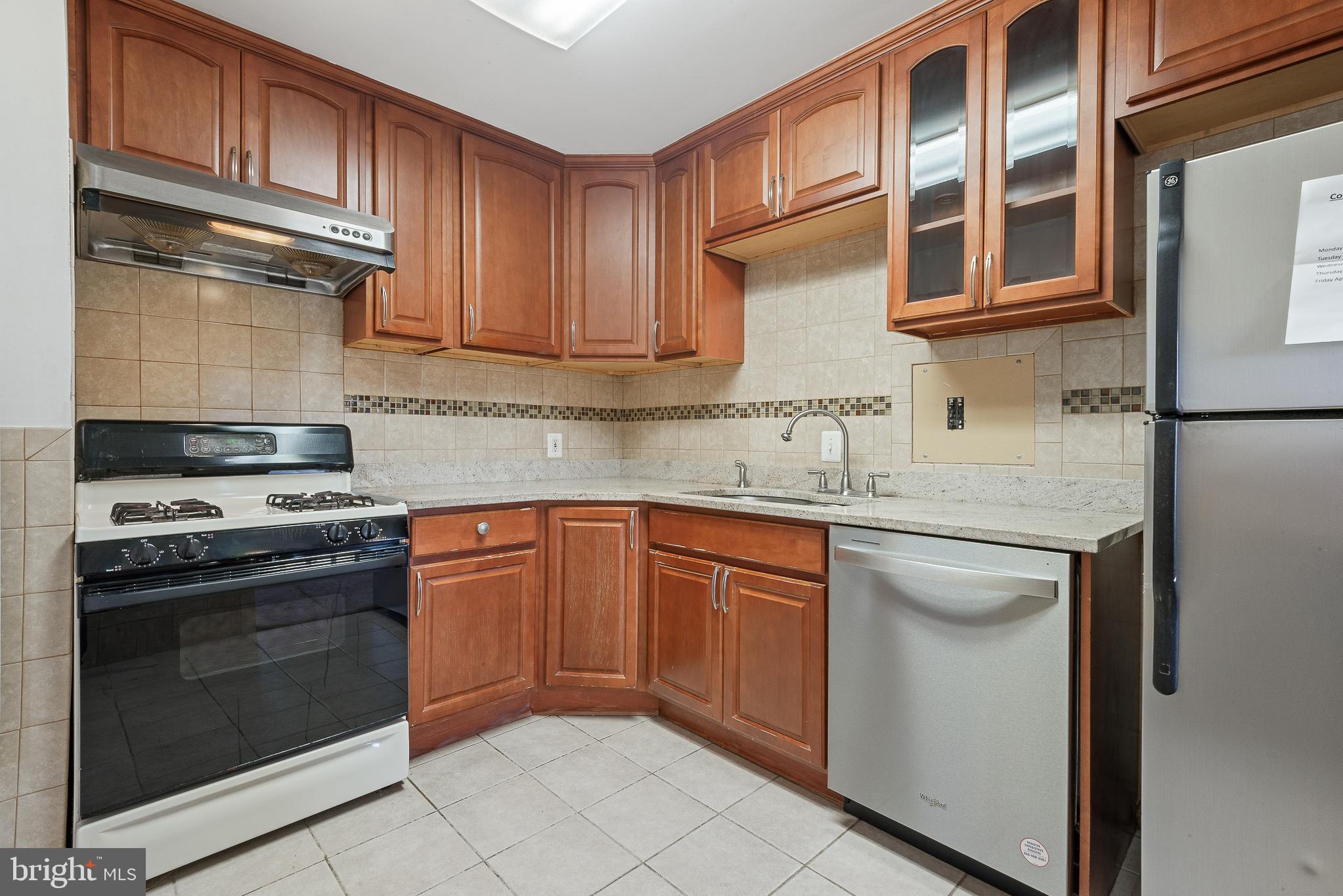 1111 University Boulevard West, Unit 805A Silver Spring, MD 20902 - Photo 16 of 33 a kitchen with stainless steel appliances granite countertop a sink stove and refrigerator