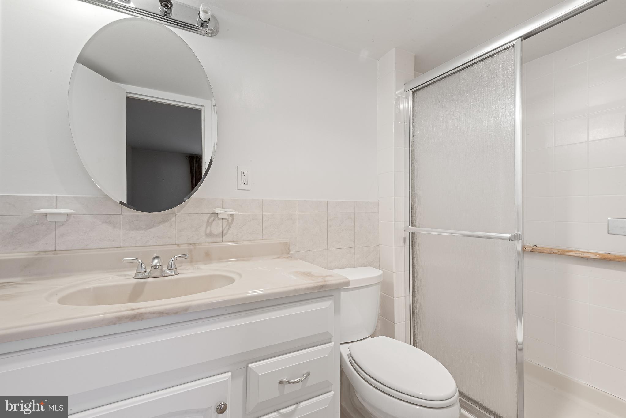 1111 University Boulevard West, Unit 805A Silver Spring, MD 20902 - Photo 24 of 33 a bathroom with a sink a toilet and shower