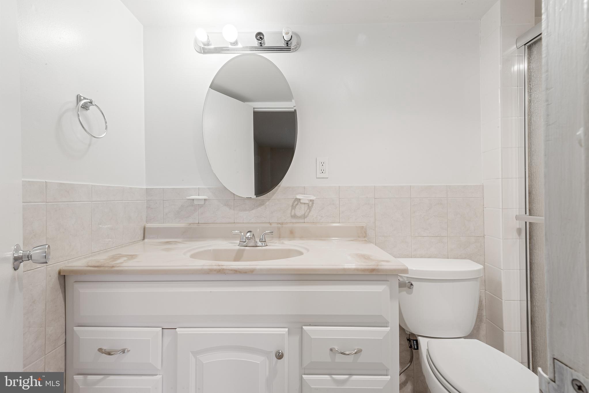 1111 University Boulevard West, Unit 805A Silver Spring, MD 20902 - Photo 25 of 33 a bathroom with a toilet sink and mirror