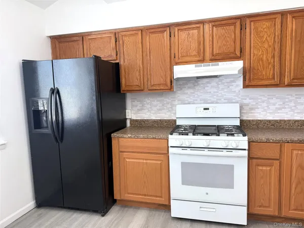 a kitchen with a stove top oven and cabinets