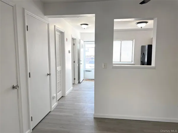 a view of a hallway with wooden floor