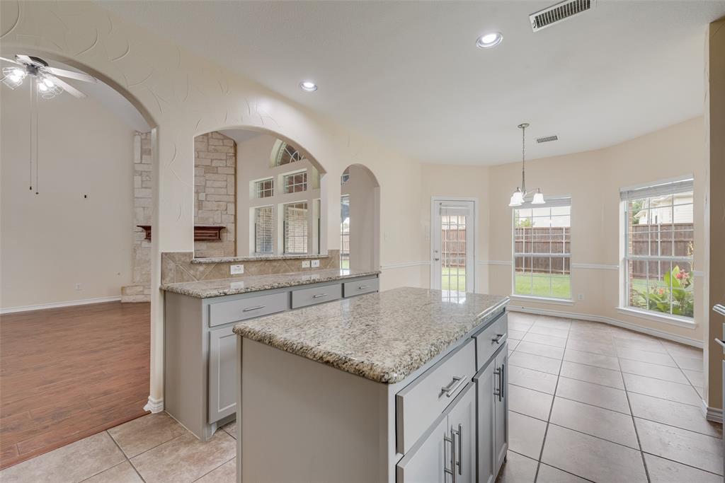 623 Lone Ridge Way Murphy, TX 75094 - Photo 40 of 40 a kitchen with granite countertop a stove and a sink