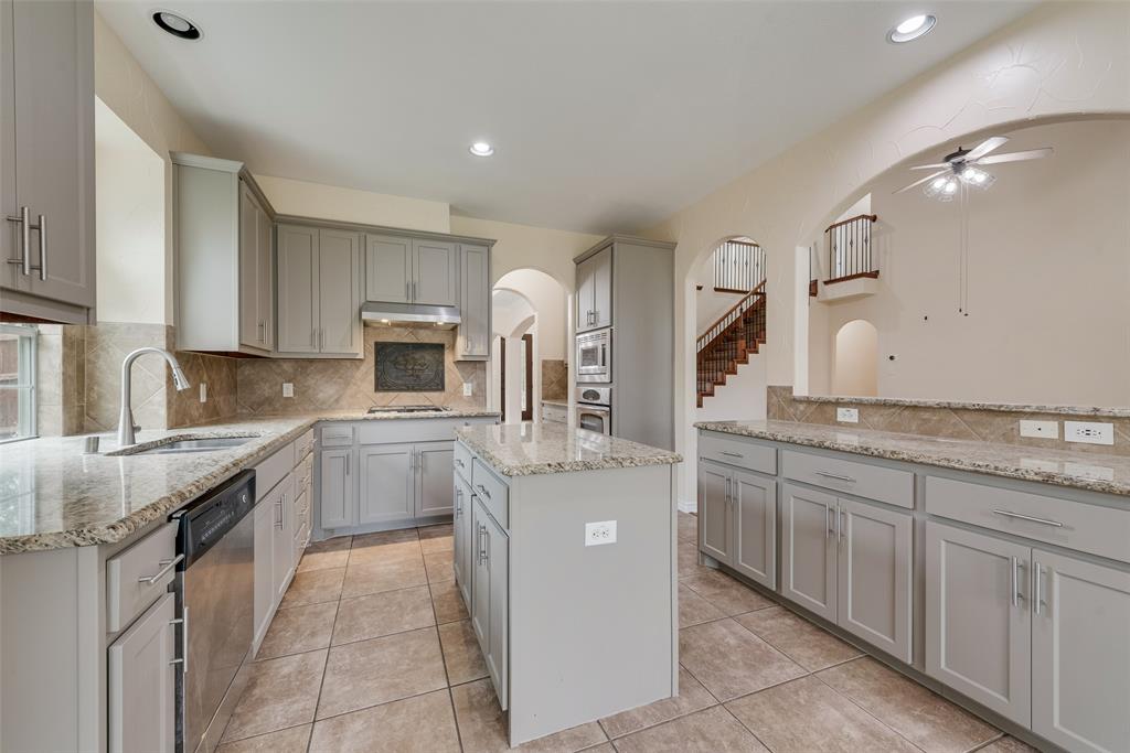 623 Lone Ridge Way Murphy, TX 75094 - Photo 16 of 40 a kitchen with stainless steel appliances granite countertop a sink counter space cabinets and stainless steel appliances