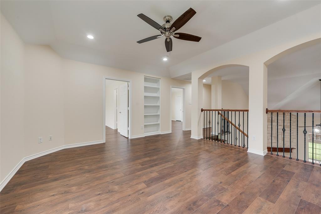 623 Lone Ridge Way Murphy, TX 75094 - Photo 27 of 40 a view of an empty room with wooden floor and a ceiling fan