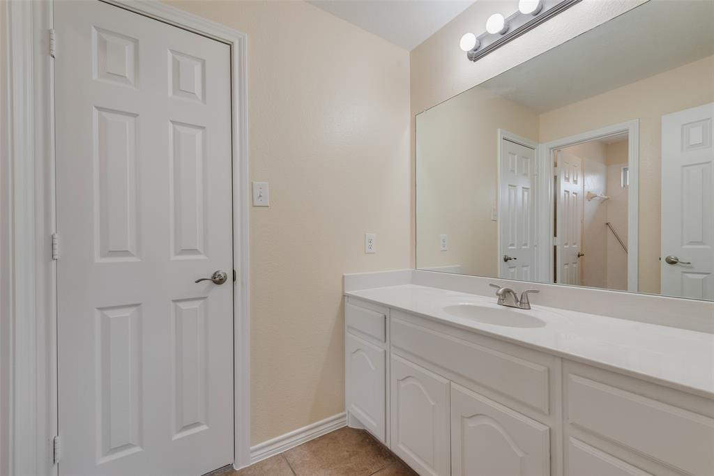 623 Lone Ridge Way Murphy, TX 75094 - Photo 35 of 40 a bathroom with a sink and a mirror