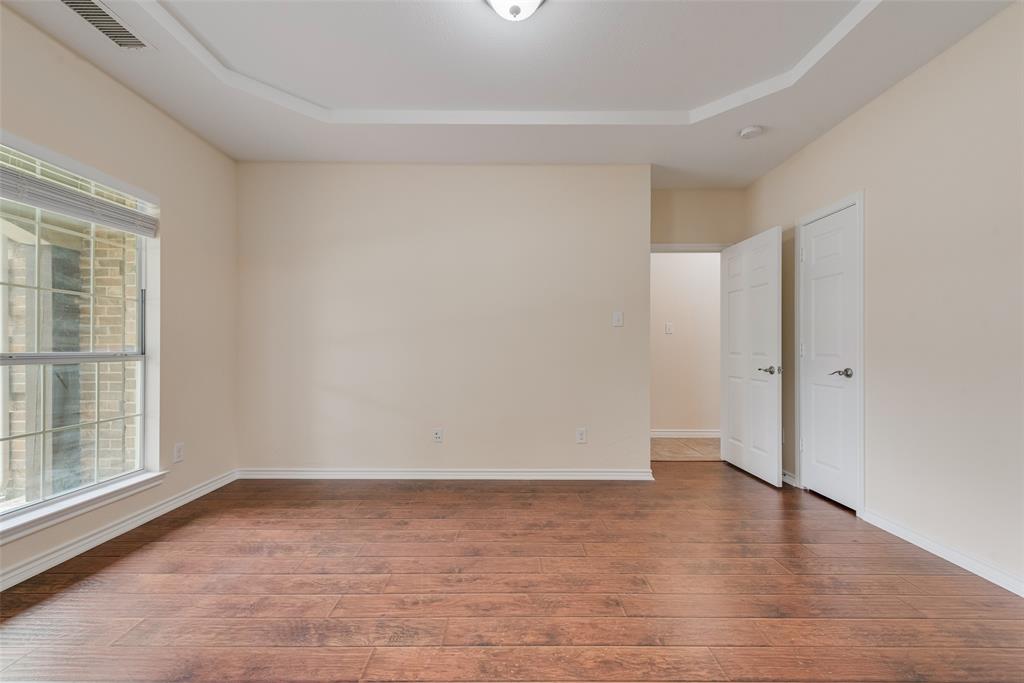623 Lone Ridge Way Murphy, TX 75094 - Photo 5 of 40 an empty room with wooden floor and windows