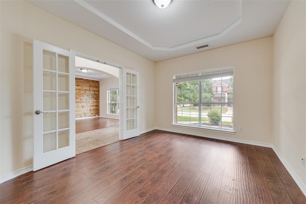 623 Lone Ridge Way Murphy, TX 75094 - Photo 6 of 40 an empty room with wooden floor and windows